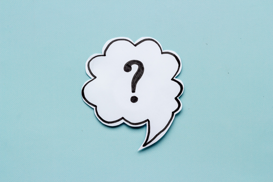 Question mark symbol on speech bubble, top view