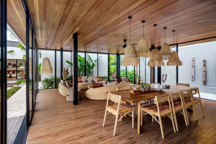 The open-plan dining room with a long wooden table for shared meals