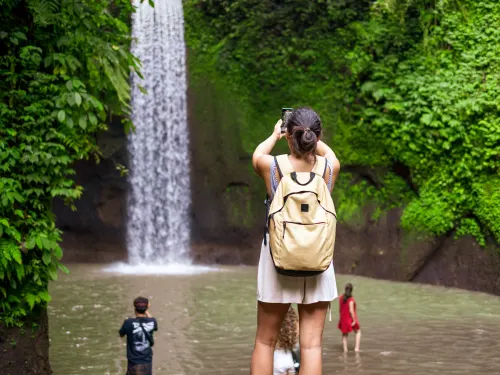 A guest photographing a waterfall