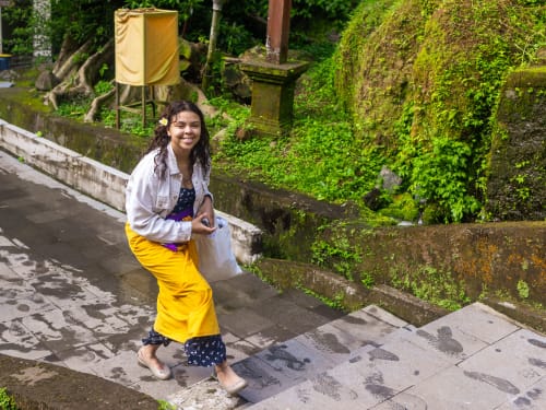 A guest in a sarong on the temple steps