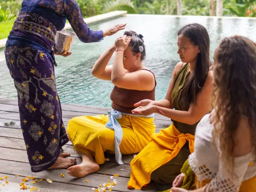 A guest receiving a water blessing during the Melukat cleansing