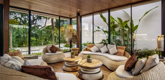 Rattan sofas in the glass-walled living room